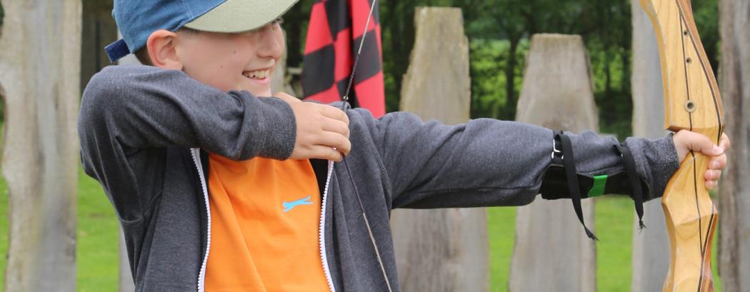 Primary school child on the archery range | JCA