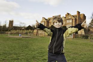 Child with thumbs up outside Condover Hall | JCA