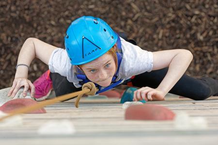 Girl determined on the climbing wall