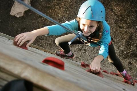 Girl rock climbing with JCA