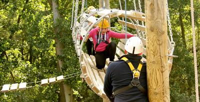 Students being supported on the high aerial trek