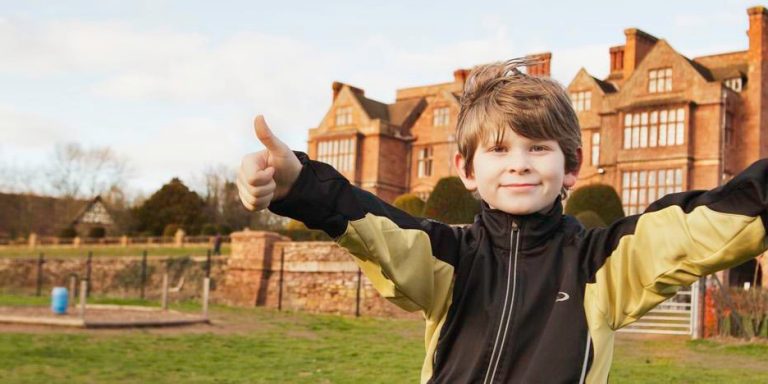 Child with thumbs up outside Condover Hall | JCA