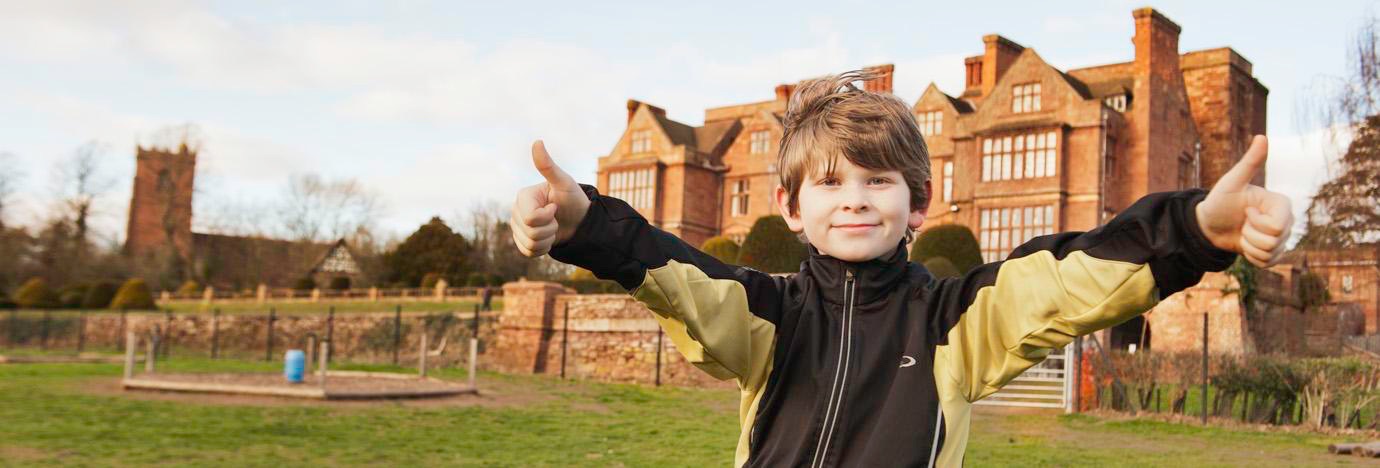 Child with thumbs up outside Condover Hall | JCA