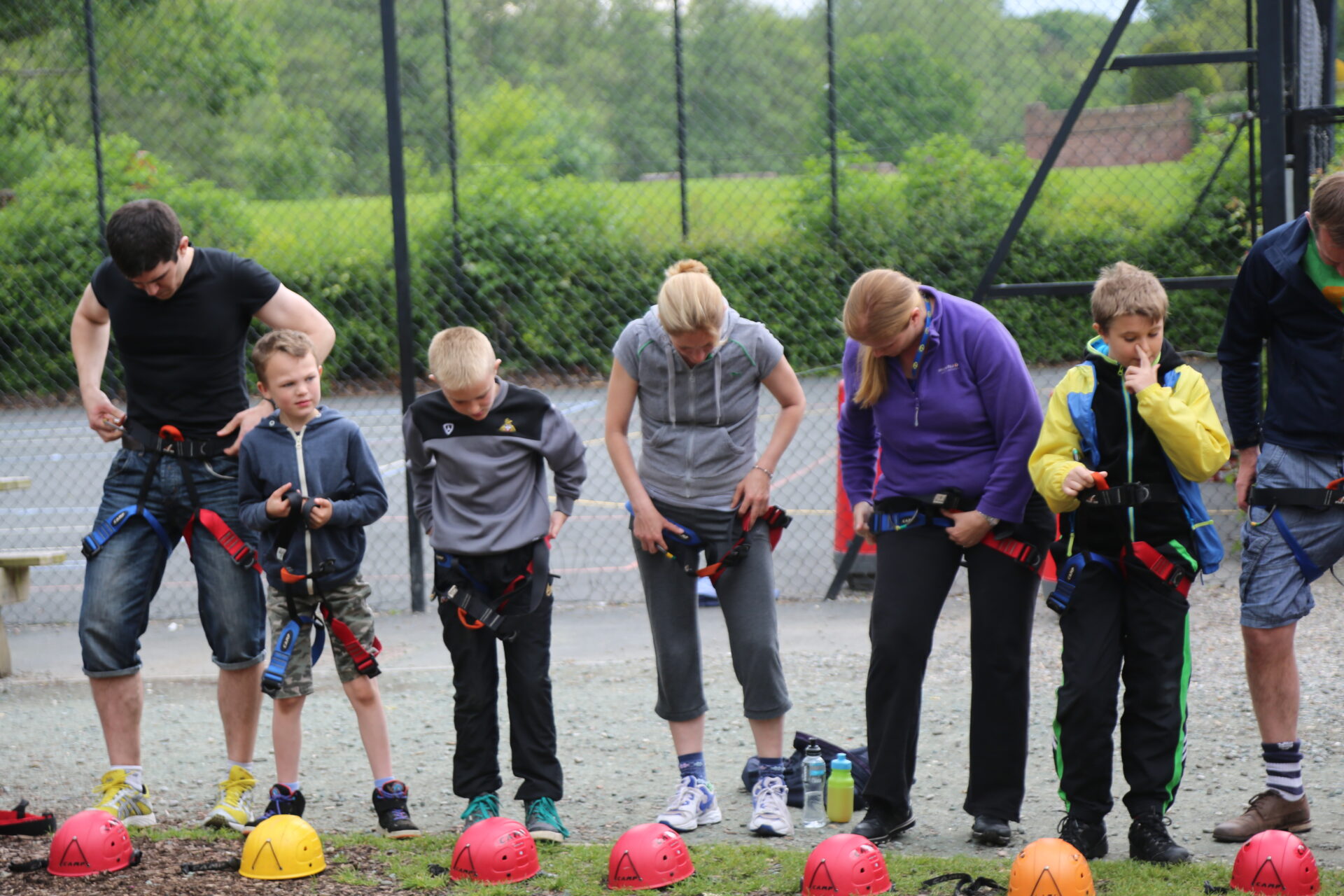 A group of people putting their harness on