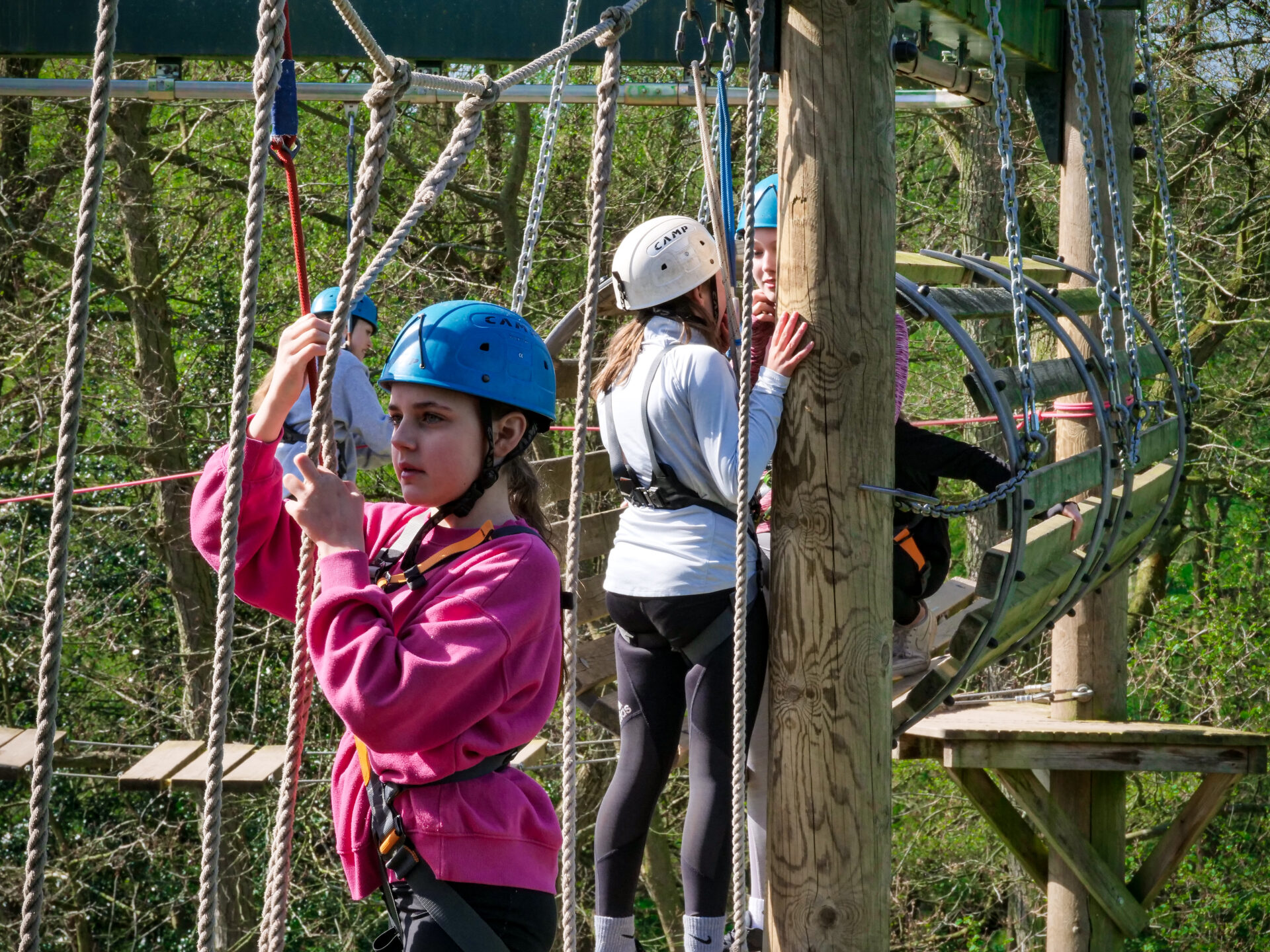 a girl on the aerial trek grabbing a rope