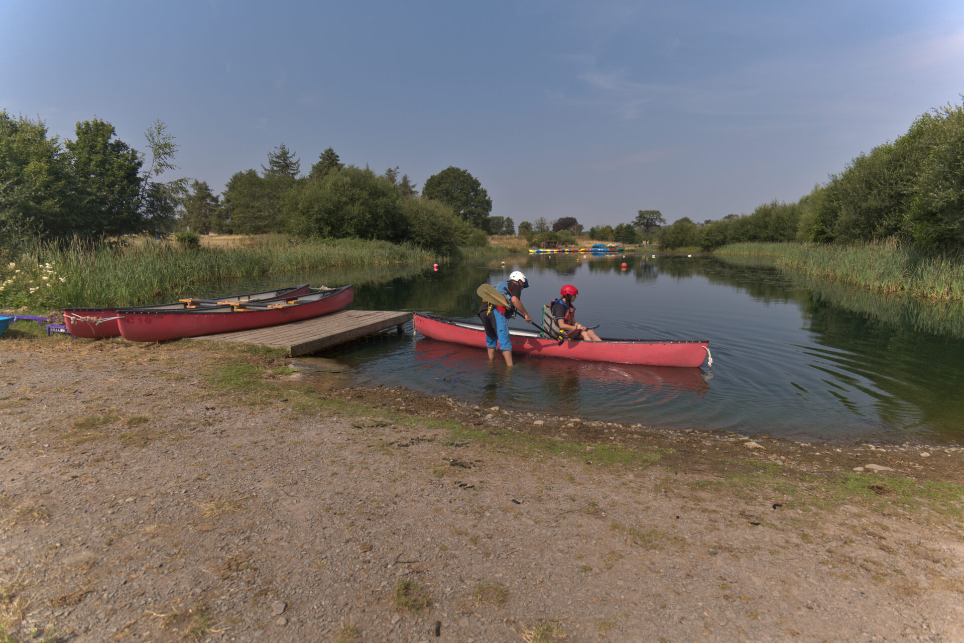 Instructor guiding a canoe with an adapted seat away from the jetty