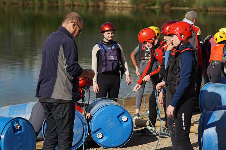 A group of students building a water raft at Croft Farm