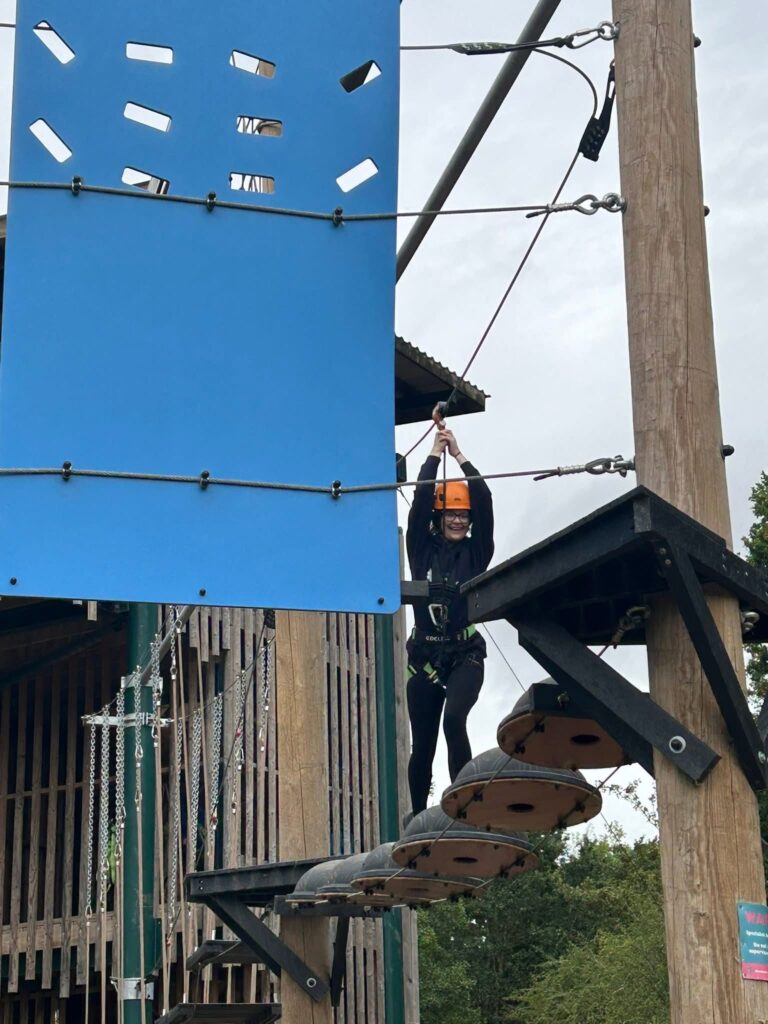A side view of an 'in-air' obstacle course, with a young person mid-course.